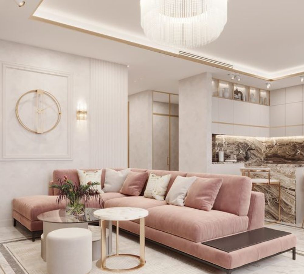 Soggiorno con divano angolare rosa e cucina a nicchia