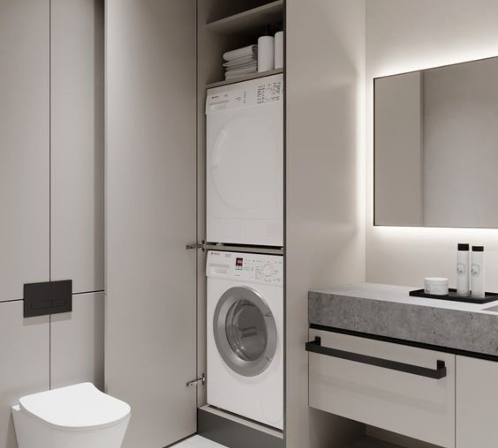 Waschmaschinenschrank und Waschtisch im hellen Bad