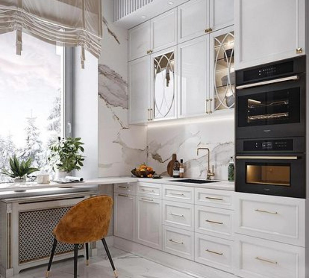 White kitchen with marble walls and a built-in oven