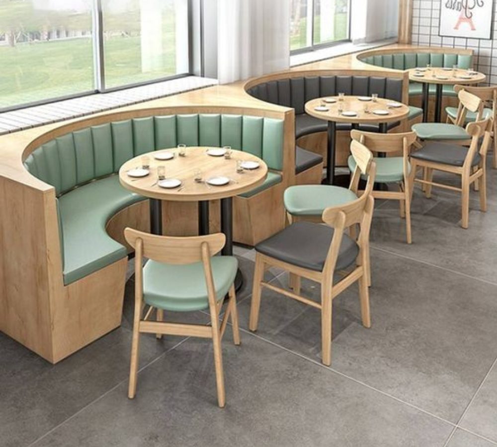 Divanetti semicircolari e sedie in legno in un ristorante