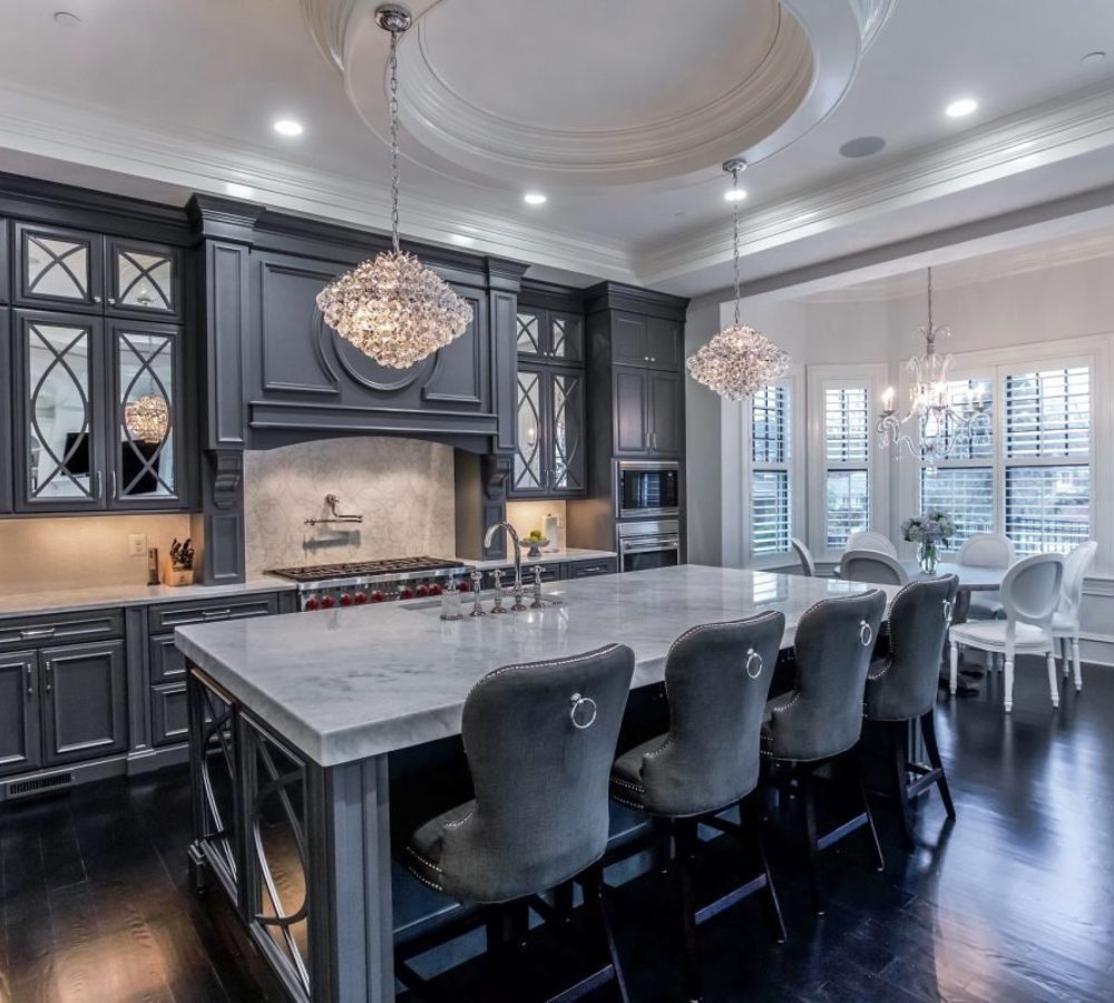 Dark classic kitchen with a long island and chairs