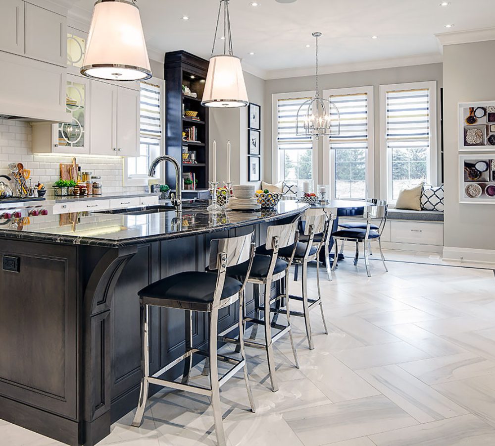 Kitchen with a dark island, bar stools and pendant lights
