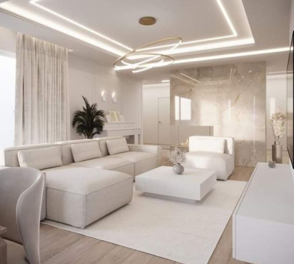 Soggiorno bianco con divano modulare e pouf