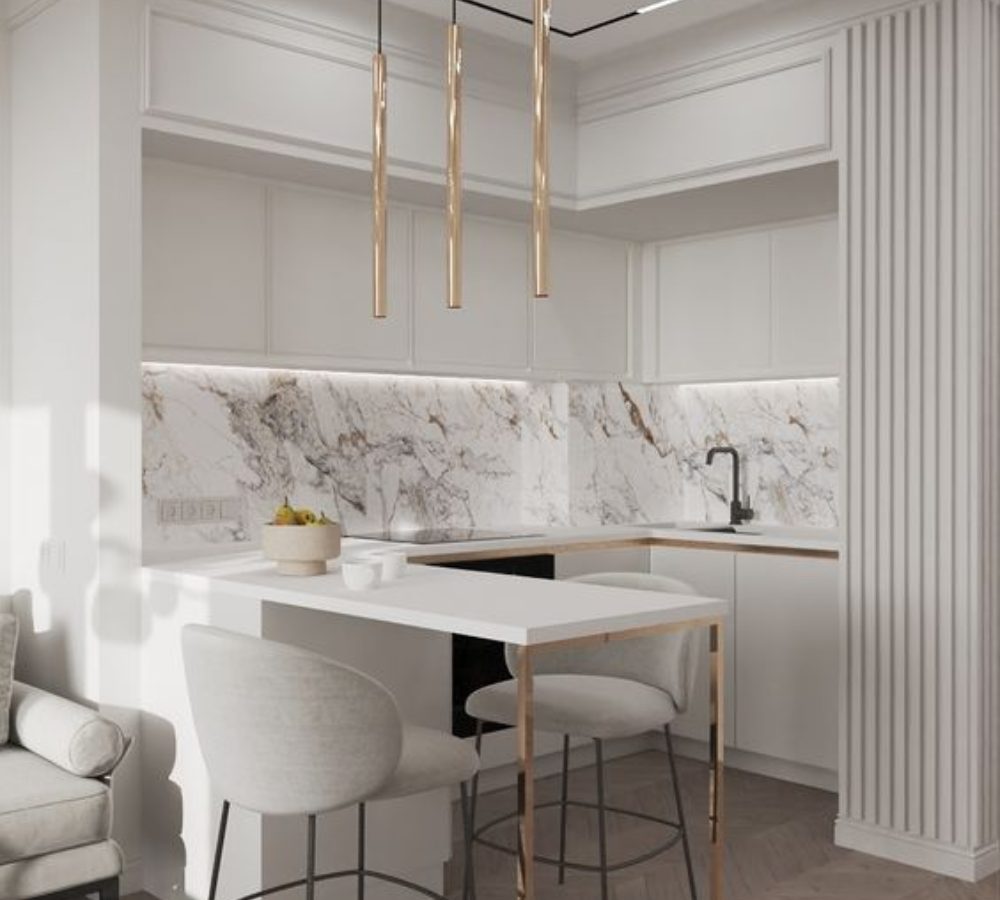 Kitchen with a marble splashback, breakfast bar and brass pendants
