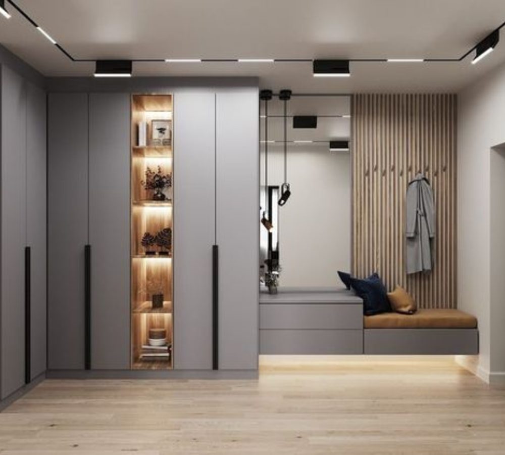 Graue Schränke mit beleuchtetem Regal und Bank mit Garderobe