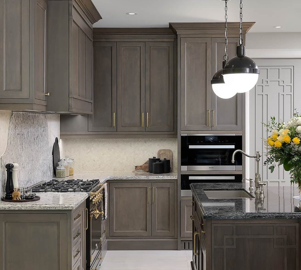 Grey kitchen with an island and black pendant lamps