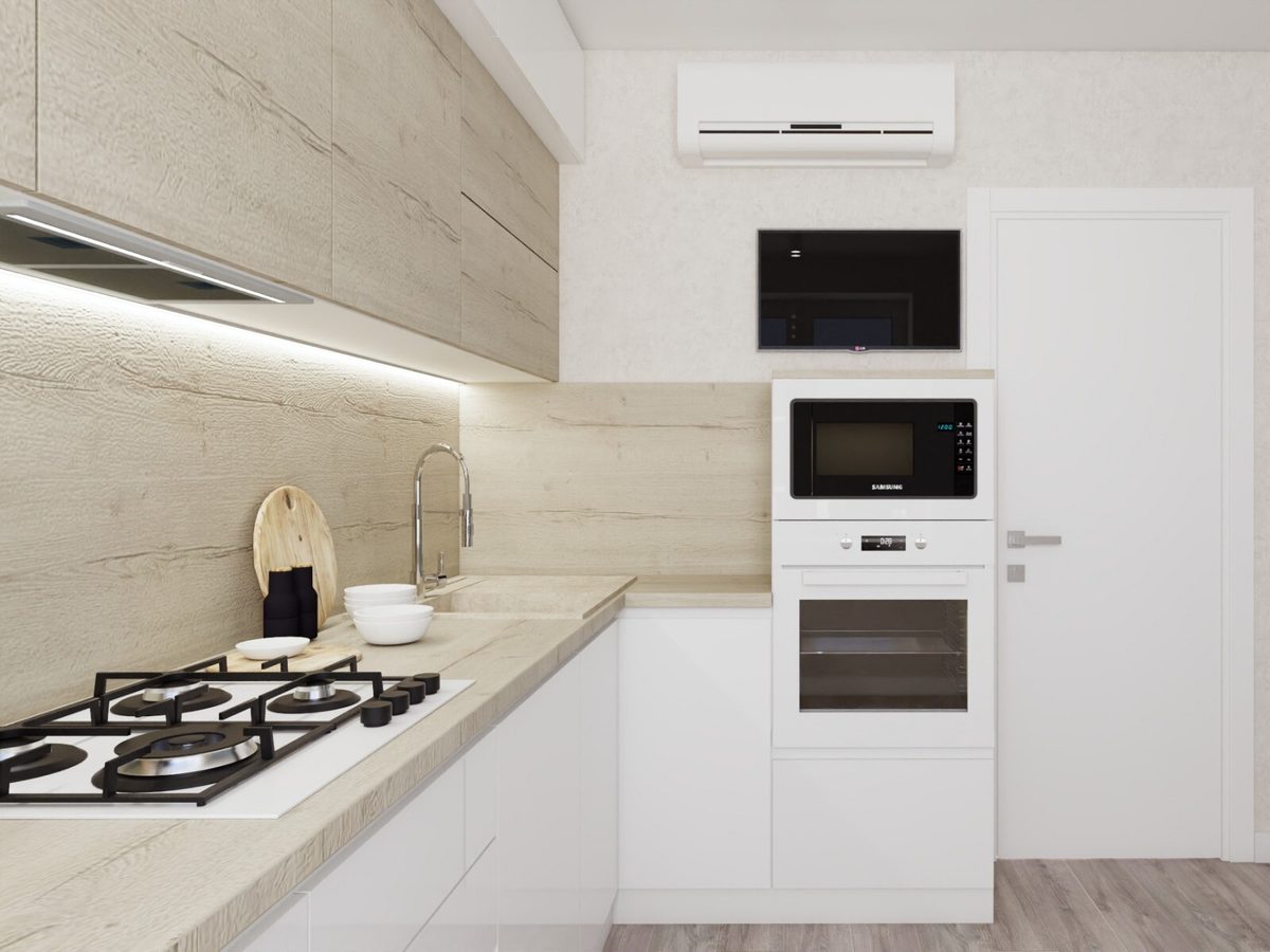 White kitchen with light wood fronts and an appliance tower